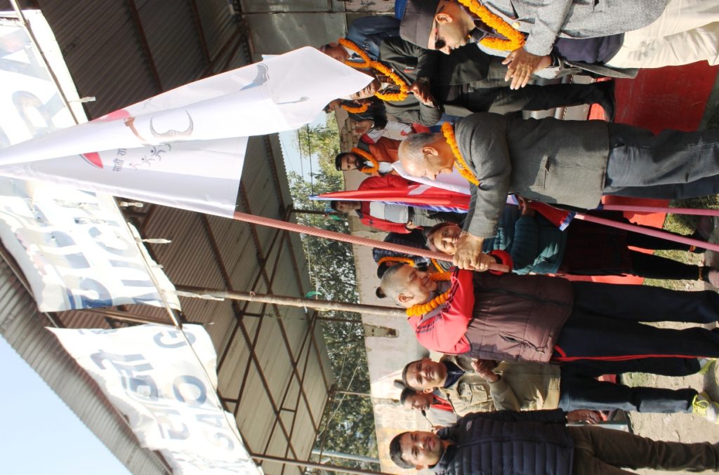 akabar-shaha-of-karate-coach-receiving-7th-national-game-flag-form-nsc-treasurer-surendra-hamal